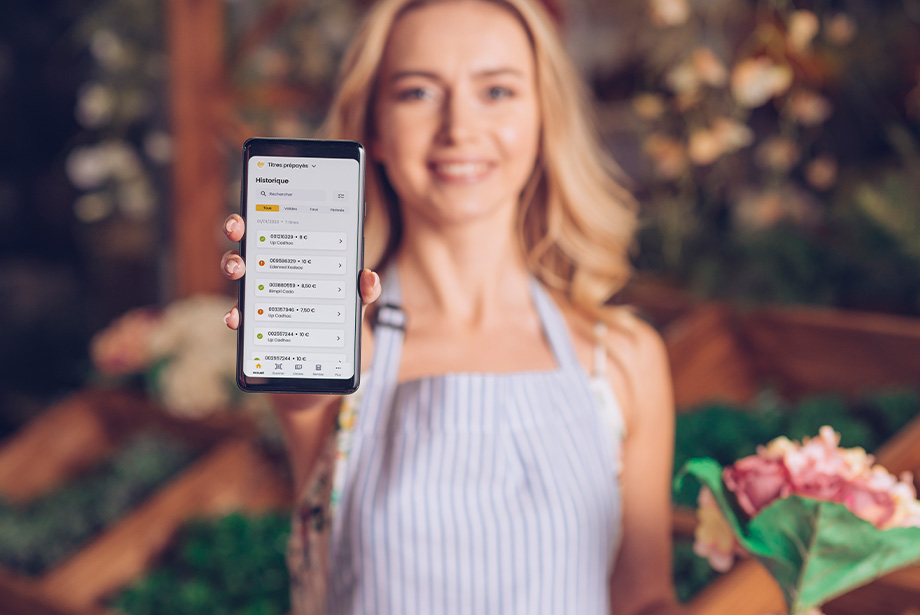 Fleuriste utilisant l'application mobile Titres Prépayés